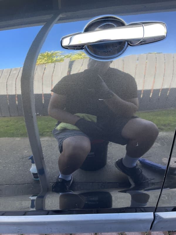 Scratch removal from vehicle side after professional detailing
